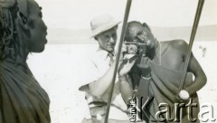 1943-1947, okolice Kidugali, Tanganika.
Polak z Masajami.
Fot. ze zbiorów Archiwum Ojców Franciszkanów w Polskiej Misji Katolickiej w Martin Coronado w Argentynie, akta ojca Justyniana Maciaszka, reprodukcje cyfrowe w  Bibliotece Polskiej im. Ignacego Domeyki w Buenos Aires (Biblioteca Polaca Ignacio Domeyko) i w Ośrodku KARTA w Warszawie