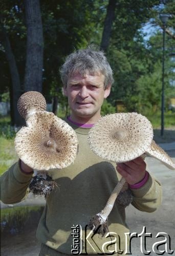 1993, Borne Sulinowo, woj. koszalińskie, Polska.
Realizacja reportażu Krystiana Przysieckiego o losach dawnego garnizonu wojskowego Armii Czerwonej i nowych mieszkańcach miasta. Mężczyzna chwali się owocami udanego grzybobrania - dorodnymi kaniami.
Fot. Mikołaj Nesterowicz, zbiory Ośrodka KARTA