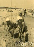 Lato 1938, Jastarnia lub Gdynia, woj. pomorskie, Rzeczpospolita Polska.
Jerzy Zajączkowski (w spodenkach na szelki) z kolegami podczas zabawy na plaży nad Morzem Bałtyckim.
Fot. NN, kolekcja Larysy Zajączkowskiej-Mitznerowej, zbiory Ośrodka KARTA