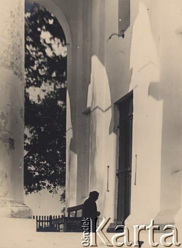 1934, Kamień Koszyrski, Poleskie woj., Polska.
Kobieta modląca się przed drzwiami kościoła.
Fot. Eugeniusz Wilczyński, zbiory Ośrodka KARTA, kolekcję Eugeniusza Wilczyńskiego udostępniła Marta Simon.
 
