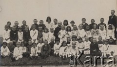 1931, Kamień Koszyrski, Poleskie woj., Polska.
I Komunia, w najwyższym rzędzie, obok kobiety w białym płaszczu, stoją Andrzej i Kazik Wilczyńscy.
Fot. NN, zbiory Ośrodka KARTA, kolekcję Eugeniusza Wilczyńskiego udostępniła Marta Simon.
 
