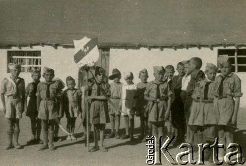 Październik 1943, Teheran, Iran.
Zuchy i ich świetlica. [Polscy uchodźcy trafili do Iranu w 1942 wraz z nowoutworzonym Wojskiem Polskim pod dowództwem generała Władysława Andersa (w dwóch rzutach ewakuacyjnych z ZSRR w marcu i sierpniu). W sumie oprócz wojska dotarło tam 38 tysięcy Polaków, z czego ponad połowę stanowiły dzieci i młodzież. W Teheranie powstały trzy obozy dla ludności cywilnej i sierociniec; stąd kierowano Polaków do stałych osiedli w różnych rejonach świata (np. w Nowej Zelandii, Ugandzie, Meksyku)].
Fot. NN, zbiory Ośrodka KARTA, kolekcja Adeli Duszy przekazała Halina Guść