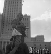 31.07.1955 - 4.08.1955, Warszawa, Polska.
V Światowy Festiwal Młodzieży i Studentów o Pokój i Przyjaźń. Fotoreporter i mężczyzna rozmawiający przez telefon pod Pałacem Kultury i Nauki
Fot. Irena Jarosińska, zbiory Ośrodka KARTA