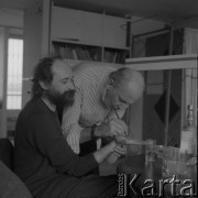 1991, Warszawa, Polska.
Edward Krasiński maluje dłoń mężczyzny w swojej pracowni przy ul. Świerczewskiego (do 1988 dzielił ją z Henrykiem Stażewskim). 
Fot. Irena Jarosińska, zbiory Ośrodka KARTA