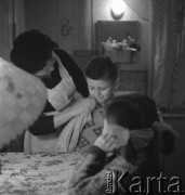 Lata 50., Chorzów, Polska.
Rodzina G.L.Cieślika przy stole. 
Gerard Józef Cieślik, pseudonim „Gienek” (ur. 29 kwietnia 1927 w Hajdukach Wielkich, obecnie dzielnica Chorzowa) – polski piłkarz, napastnik, zawodnik Ruchu Chorzów, słuchajacy radia. Zasłynął strzeleniem dwóch bramek Związkowi Radzieckiemu 20 października 1957 na Stadionie Śląskim w Chorzowie.
Fot. Irena Jarosińska, zbiory Ośrodka KARTA