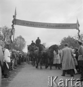 1958, Polska.
Z okazji 400 rocznicy założenia Poczty Polskiej, trasą Kielce-Wrocław przejechał zabytkowy dyliżans pocztowy. Nz. zaprzęg pocztowy przejeżdża przez bramę powitalną.
Fot. Irena Jarosińska, zbiory Ośrodka KARTA