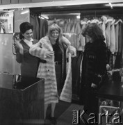 1968-1972, Nowy Targ, Polska.
Sklep Banku PeKaO. Kobieta mierzy futro.
Fot. Irena Jarosińska, zbiory Ośrodka KARTA