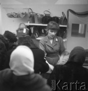 Lata 50., Warszawa, Polska.
Sprzedawczyni obsługuje klientki w salonie Cepelii przy ul. Rutkowskiego (obecnie Chmielna).
Fot. Irena Jarosińska, zbiory Ośrodka KARTA 
