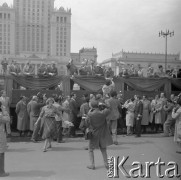 1.05.1959, Warszawa, Polska. 
Obchody święta 1 Maja, ulica Marszałkowska, widok na trybunę honorową i zgromadzonych przed nią dziennikarzy, którzy obserwują kobietę zwróconą do przewodniczącego Rady Państwa Aleksandra Zawadzkiego. Piąty od lewej stoi premier Józef Cyrankiewicz, kolejny I sekretarz KC PZPR Władysław Gomułka, w jasnym kapeluszu prezydent Indonezji Ahmed Sukarno, w tle fragment Pałacu Kultury i Nauki. 
Fot. Romuald Broniarek, zbiory Ośrodka KARTA