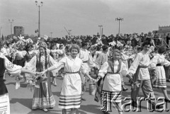 1.05.1959, Warszawa, Polska. 
Obchody święta 1 Maja, pochód idący ulicą Marszałkowską, uczestnicy w strojach ludowych reprezentujący Cepelię, w tle trybuna honorowa. 
Fot. Romuald Broniarek, zbiory Ośrodka KARTA