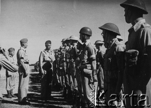 1943-1944, Bliski Wschód.
Wódz Naczelny Polskich Sił Zbrojnych gen. Kazimierz Sosnkowski (stoi 1. z lewej przodem do żołnierzy) w trakcie wizytacji Armii Polskiej na Wschodzie. Obok K. Sosnkowskiego gen. Władysław Anders (stoi bokiem)
Fot. NN, zbiory Ośrodka KARTA, przekazał Józef Bieńkowski
