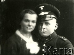 1939-1941, Kozienice, Polska.
Niemiecki żołnierz w mundurze oraz młoda kobieta.
Zdjęcie wykonane w atelier fotograficznym żydowskiego fotografa Chaima Bernemana. Przed wojną zakład mieścił się w Kozienicach na rogu ulic Warszawskiej i Maciejowickiej, przed wybuchem wojny albo już w czasie niemieckiej okupacji  został przeniesiony na ulicę Lubelską 13. Cała kolekcja jest datowana na okres od drugiej połowy lat 30-tych do roku 1941, kiedy Chaim Berneman wraz z rodziną został zesłany do obozu pracy w Wolanowie. Berneman zmarł po ucieczce z obozu.
Fot. Chaim Berneman (Chaim Berman), zbiory Ośrodka KARTA