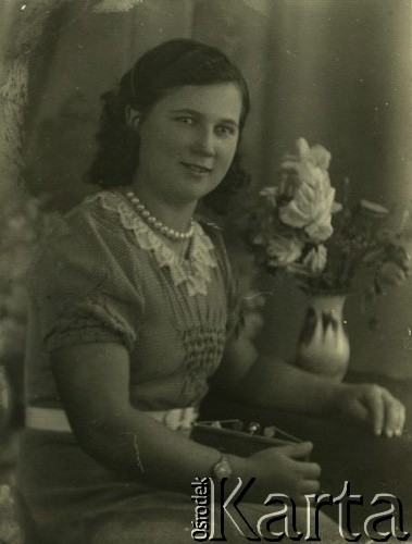 Druga połowa lat 30. do 1941, Kozienice, Polska.
Portret młodej kobiety w sukience z białym kołnierzykiem.
Zdjęcie wykonane w atelier fotograficznym żydowskiego fotografa Chaima Bernemana. Przed wojną zakład mieścił się w Kozienicach na rogu ulic Warszawskiej i Maciejowickiej, przed wybuchem wojny albo już w czasie niemieckiej okupacji  został przeniesiony na ulicę Lubelską 13. Cała kolekcja jest datowana na okres od drugiej połowy lat 30-tych do roku 1941, kiedy Chaim Berneman wraz z rodziną został zesłany do obozu pracy w Wolanowie. Berneman zmarł po ucieczce z obozu.
Fot. Chaim Berneman (Chaim Berman), zbiory Ośrodka KARTA