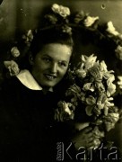 Druga połowa lat 30. do 1941, Kozienice, Polska.
Portret dziewczyny z girlandą kwiatów.
Zdjęcie wykonane w atelier fotograficznym żydowskiego fotografa Chaima Bernemana. Przed wojną zakład mieścił się w Kozienicach na rogu ulic Warszawskiej i Maciejowickiej, przed wybuchem wojny albo już w czasie niemieckiej okupacji  został przeniesiony na ulicę Lubelską 13. Cała kolekcja jest datowana na okres od drugiej połowy lat 30-tych do roku 1941, kiedy Chaim Berneman wraz z rodziną został zesłany do obozu pracy w Wolanowie. Berneman zmarł po ucieczce z obozu.
Fot. Chaim Berneman (Chaim Berman), zbiory Ośrodka KARTA