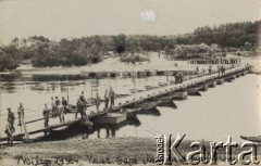 1930, Wilno, Polska.
Koncentracja saperów. Zbudowany w ramach ćwiczeń przez saperów 6 Batalionu Saperów z Twierdzy Brzeskiej most pontonowy na rzece Wilja. Żołnierze stojący na moście oraz na brzegu rzeki.
Fot. Józef Tarań, zbiory Ośrodka KARTA, kolekcję zdjęć przekazała Lucyna Kumiszczo