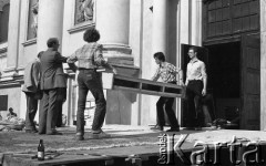 Po 13.05.1981, Warszawa, Polska.
Przygotowania przed Kościołem św. Anny do mszy zorganizowanej po zamachu na papieża Jana Pawła II - mężczyźni przenoszą podest.
Fot. NN, zbiory Ośrodka KARTA/Independent Polish Agency (IPA) przekazał Józef Lebenbaum