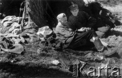 01-02.08.1944, okolice wsi Chorodyszcze, Puszcza Grodzieńska, pow. Grodno.
Oddział partyzancki Bazy z Kedywu Komendy Okręgu Wileńskiego AK podczas obozowania w lesie nad rzeką Kotrą, na północ od spalonej wsi Chorodyszcze. Przed szałasem siedzą plut. Jan Nasutto 