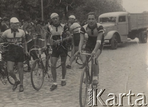 1939, Mazowsze, Polska.
Wyścig kolarski na 75 km (trasa: Warszawa - Nowy Dwór Mazowiecki - Warszawa). Na zdjęciu, na pierwszym planie, uczestnicy: (od prawej) Roman Bukowski, Stefan Szrama oraz Lewandowski (?). W tle widzowie ubrani w płaszcze oraz ciężarówka.
Fot. NN, zbiory Ośrodka Karta, udostępniło Warszawskie Towarzystwo Cyklistów (WTC).