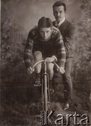 Początek XX wieku, Warszawa, Polska pod zaborem rosyjskim.
Piotr Tkaczyk (na rowerze, wielokrotny mistrz Polski i zwycięzca zawodów międzynarodowych) z Wacławem Wyczałkowskim.  Zdjęcie pozowane w atelier fotograficznym.
Fot. NN, zbiory Ośrodka Karta, udostępniło Warszawskie Towarzystwo Cyklistów (WTC).