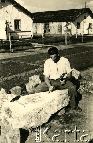 1940, Targu-Jiu, Rumunia.
Obóz internowania dla żołnierzy Wojska Polskiego, artysta rzeźbiarz podczas pracy nad polskim godłem, w tle obozowe baraki. 
 Fot. NN, zbiory Ośrodka Karta, album (A-XIII). Zdjęcie ze zbioru ocalonego przez pracownika ambasady PRL w Bukareszcie Jerzego Polakowskiego
   
