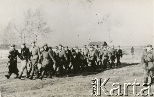 1-2.02.1944, Wojcieszuny.
Pierwszy pluton 6 Wileńskiej Samodzielnej Brygady Partyzanckiej Armii Krajowej ćwiczy musztrę zwartą. Ćwiczenia prowadzi plutonowy podchorąży Wincenty Borodziewicz ps. Szkrab (idzie z prawej).
Fot. NN, kolekcja Wincentego Borodziewicza, zbiory Ośrodka KARTA, przekazała Wanda Borodziewicz