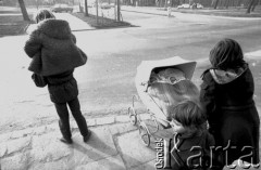 1982, Kraków, Polska.
Kobieta przeprowadza przez ul. Czarnowiejską wózek z dwójką malutkich dzieci w środku.
Fot. Piotr Dylik, zbiory Ośrodka KARTA