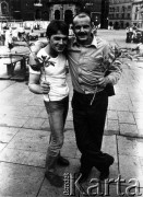 Lata 80., Kraków, Polska.
Dwaj kibice z kwiatami na Rynku Głównym. Za nimi Bazylika Mariacka.
Fot. Piotr Dylik, zbiory Ośrodka KARTA