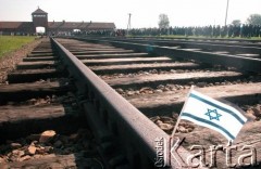 1992, Oświęcim, Polska.
KL Auschwitz Birkenau. Tory kolejowe, bocznica obozowa. Na torowisku mała flaga Izraela. Rampa obozowa. W tle wartownia i brama obozowa. Marsz żywych.
Fot. Piotr Dylik, zbiory Ośrodka KARTA