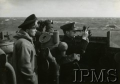 1940-1946, brak miejsca.
ORP Garland, marynarze (od lewej) - porucznik Witold Wojciechowski, NN, porucznik Antoni Tyc - obserwują morze. Jeden z marynarzy używa sekstantu (optyczny przyrząd nawigacyjny  służący do mierzenia wysokości ciał niebieskich nad horyzontem, a także kątów poziomych i pionowych pomiędzy obiektami widocznymi na Ziemi).
Fot. NN, Instytut Polski i Muzeum im. gen. Sikorskiego w Londynie [szuflada 39, sygnatura 30784]