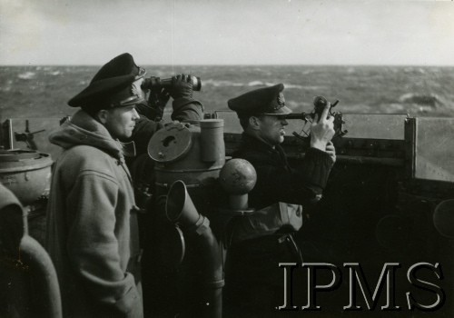 1940-1946, brak miejsca.
ORP Garland, marynarze (od lewej) - porucznik Witold Wojciechowski, NN, porucznik Antoni Tyc - obserwują morze. Jeden z marynarzy używa sekstantu (optyczny przyrząd nawigacyjny  służący do mierzenia wysokości ciał niebieskich nad horyzontem, a także kątów poziomych i pionowych pomiędzy obiektami widocznymi na Ziemi).
Fot. NN, Instytut Polski i Muzeum im. gen. Sikorskiego w Londynie [szuflada 39, sygnatura 30784]