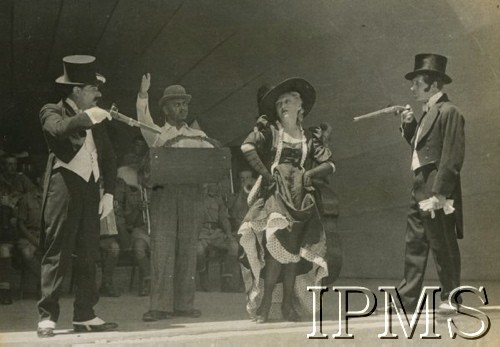 1942, Teheran, Iran.
Występ w obozie dla polskich uchodźców, aktorzy w scenie pojedynku, w tle orkiestra.
Fot. NN, Instytut Polski i Muzeum im. gen. Sikorskiego w Londynie [album Ludwika Naimskiego].