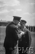 24.06.1943, Northolt, Anglia, Wielka Brytania.
Dywizjon 303, dekoracji mjr. pil. Wojciecha Kołaczkowskiego Krzyżem DFC (Distingnished Flying Cross) dokonuje generał William Sholto-Douglas, dowódca lotnictwa myśliwskiego RAF.
Fot. NN, Instytut Polski i Muzeum im. gen. Sikorskiego w Londynie