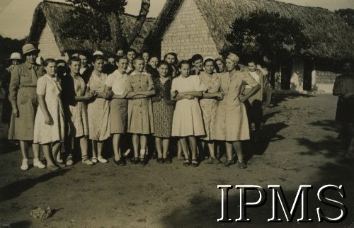 1943, Ifunda, Tanganika.
Grupa mieszkańców osiedla.
[Polscy uchodźcy w 1942 trafili do Iranu wraz z nowoutworzonym Wojskiem Polskim pod dowództwem generała Władysława Andersa (w dwóch rzutach ewakuacyjnych z ZSRR w marcu i sierpniu). W sumie oprócz wojska dotarło tam 38 tysięcy Polaków, z czego ponad połowę stanowiły dzieci i młodzież. Ok. 20 tys. znalazło się następnie w Afryce, polskie osiedla znajdowały się przede wszystkim w: Ugandzie, Kenii, Tanganice, Rodezji Północnej i Rodezji Południowej, Związku Południowej Afryki].
Fot. NN, Instytut Polski i Muzeum im. gen. Sikorskiego w Londynie [album 288 - gen. Andersowi uchodźstwo w Afryce Wsch. 19.07.1943, w albumie dedykacja: panu generałowi Władysławowi Andersowi w imieniu uchodźstwa w Afryce inż. K. Kazimierczak, delegat MPiOS Nairobi].
