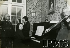 1928-1939, Polska.
Oficerowie i kobiety przy pianinie, na skrzypcach gra major z 31 Pułku Strzelców Kaniowych.
Fot. NN, Instytut Polski i Muzeum im. gen. Sikorskiego w Londynie [Album majora artylerii Olszewskiego z lat 1928-39, zamordowanego w Katyniu; przekazany do IPiMS przez Edwarda Mikesa, Londyn]
