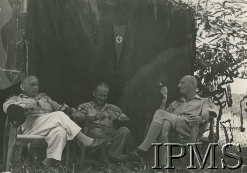 1944, Włochy.
Przed namiotem siedzą od lewej: płk Bronisław Rakowski (?), szef sztabu 2 Korpusu płk Kazimierz Wiśniowski i gen. Władysław Anders, na ścianie namiotu wisi niemiecki proporczyk ze swastyką.
Fot. NN, Instytut Polski i Muzeum im. gen. Sikorskiego w Londynie