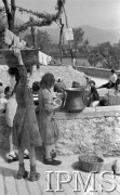 Maj 1944, Cassino, Włochy.
Rodzajowa scena na ulicy - dziewczęta przy studni.
Fot. por. Ostrowski, Instytut Polski im. Gen. Sikorskiego w Londynie [album negatywowy L-II Monte Cassino] - płachta 6
