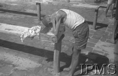 Październik 1942, Teheran, Iran (Persja).
Obóz dla polskich uchodźców nr 4. Chłopiec myjący się w misce zrobionej z blaszanego pudełka.
Fot. NN, Instytut Polski im. Gen. Sikorskiego w Londynie [album negatywowy B-I IRAN] - płachta 38