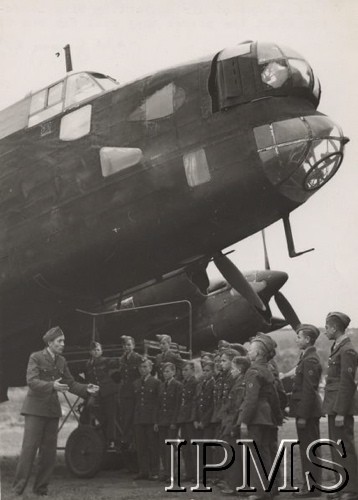 1941-1945, Wielka Brytania.
Szkoła dla maloletnich Polskich Sił Powietrznych. Grupa junaków z instruktorem na lotnisku obok samolotu bombowego.
Fot. NN, Instytut Polski i Muzeum im. gen. Sikorskiego w Londynie [teczka nr 26]