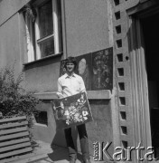 1982, Kraków, Polska.
Artysta malarz Antoni Kwiek prezentuje swoje prace przy wejściu do bloku mieszkalnego na nowohuckim osiedlu.
Fot. Stanisław Gawliński, zbiory Ośrodka KARTA
