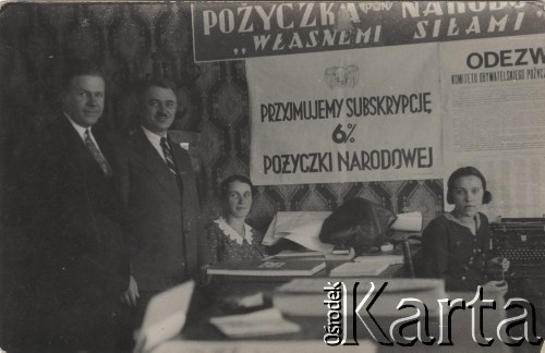 24.09.1933, Stołpce, woj. Nowogródek, Polska.
Pracownicy Komunalnej Kasy Oszczędności. Na ścianie ogłoszenie 