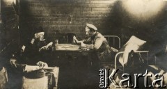 1915-1918, prawdopodobnie Ukraina.
Żołnierze 6 Gospodarczego Czołowego Oddziału Sanitarnego (przemianowanego później na Korpusową Kolumnę Sanitarną) imperialnej armii rosyjskiej grający w karty. Oddział przeszedł w 1917/1918 roku do II Korpusu Polskiego na Wschodzie.
Fot. NN, zbiory Ośrodka KARTA, przekazała Wanda Ustaszewska-Szamborska