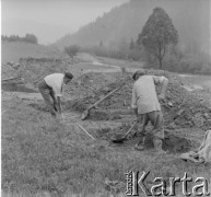 Lata 50., Bieszczady, Polska.
Mężczyźni kopią ziemię na miejscu budowy. W dalszym planie widoczny dach domu mieszkalnego.
Fot. Jerzy Konrad Maciejewski, zbiory Ośrodka KARTA.