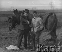 Kwiecień 1941, Kerzers, Szwajcaria.
Rolnik szwajcarski (z lewej) częstuje jedzeniem internowanego żołnierza polskiego z 2. Dywizji Strzelców Pieszych. Z tyłu za nimi stoją dwa konie. 
Fot. Jerzy Konrad Maciejewski, zbiory Ośrodka KARTA