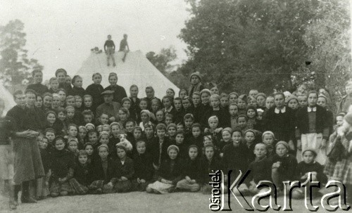 Listopad 1942, Jussuf-Abad, Iran.
Polskie dzieci z ochronki w obozie cywilnym nr 3.
[Polscy uchodźcy w 1942 trafili do Iranu wraz z nowoutworzonym Wojskiem Polskim pod dowództwem generała Władysława Andersa (w dwóch rzutach ewakuacyjnych z ZSRR w marcu i sierpniu). W sumie oprócz wojska dotarło tam 38 tysięcy Polaków, z czego ponad połowę stanowiły dzieci i młodzież. Ok. 20 tys. znalazło się następnie w Afryce, polskie osiedla znajdowały się przede wszystkim w: Ugandzie, Kenii, Tanganice, Rodezji Północnej i Rodezji Południowej, Związku Południowej Afryki. Tengeru było największym polskim osiedlem uchodźczym w Afryce].
Fot. NN, zbiory Ośrodka KARTA, przekazała Lucyna Zasuwik