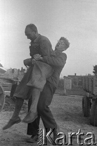 1943, Jaworów, woj. Lwów
Baza remontowa traktorów na terenie dawnej elektrowni, Kazimierz Seko mocuje się z Dąbrowieckim.
Fot. Kazimierz Seko, zbiory Ośrodka KARTA
 
