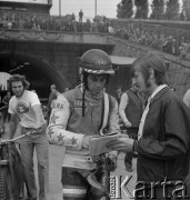 1973, Chorzów, Polska.
Indywidualne Mistrzostwa Świata na żużlu, zawodnik w kombinezonie i kasku ochronnym składający autograf ma programie zawodów.
Fot. Kazimierz Seko, zbiory Ośrodka KARTA