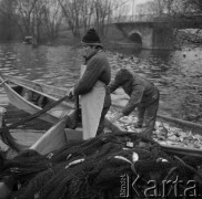 20-21.11.1979, Ostróda, woj. olsztyńskie, Polska.
Rybacy Zespołu Ostróda. Połów ryb - wyciąganie sieci. W oddali widoczny jest most oraz drzewa.
Fot. Jarosław Tarań, zbiory Ośrodka KARTA [79-21] 
