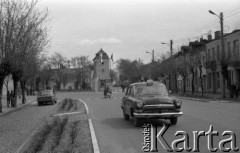 Maj 1979, Nasielsk, woj. ciechanowskie, Polska.
Fragment miasta - przejeżdżająca taksówka, przechodnie, domy, drzewa.
Fot. Jarosław Tarań, zbiory Ośrodka KARTA [79-52] 
