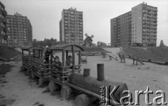 13.10.1979, Gorzów Wielkopolski, woj. gorzowskie, Polska.
Osiedle mieszkaniowe - plac zabaw. Dzieci bawiące się w drewnianej zabawce w kształcie pociągu. W oddali widoczne są hustawki, drewniana imitacja wiatraka oraz wieżowce.
Fot. Jarosław Tarań, zbiory Ośrodka KARTA [79-57] 
