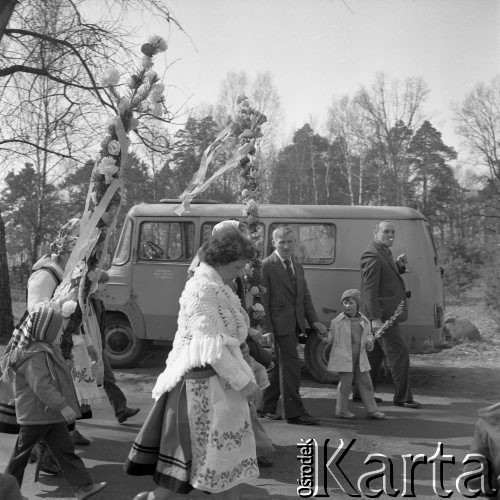 12.04.1981, Łyse, woj. Ostrołęka, Polska
Niedziela Palmowa na Kurpiach, kobiety w kurpiowskich strojach z palmami, w tle samochód 